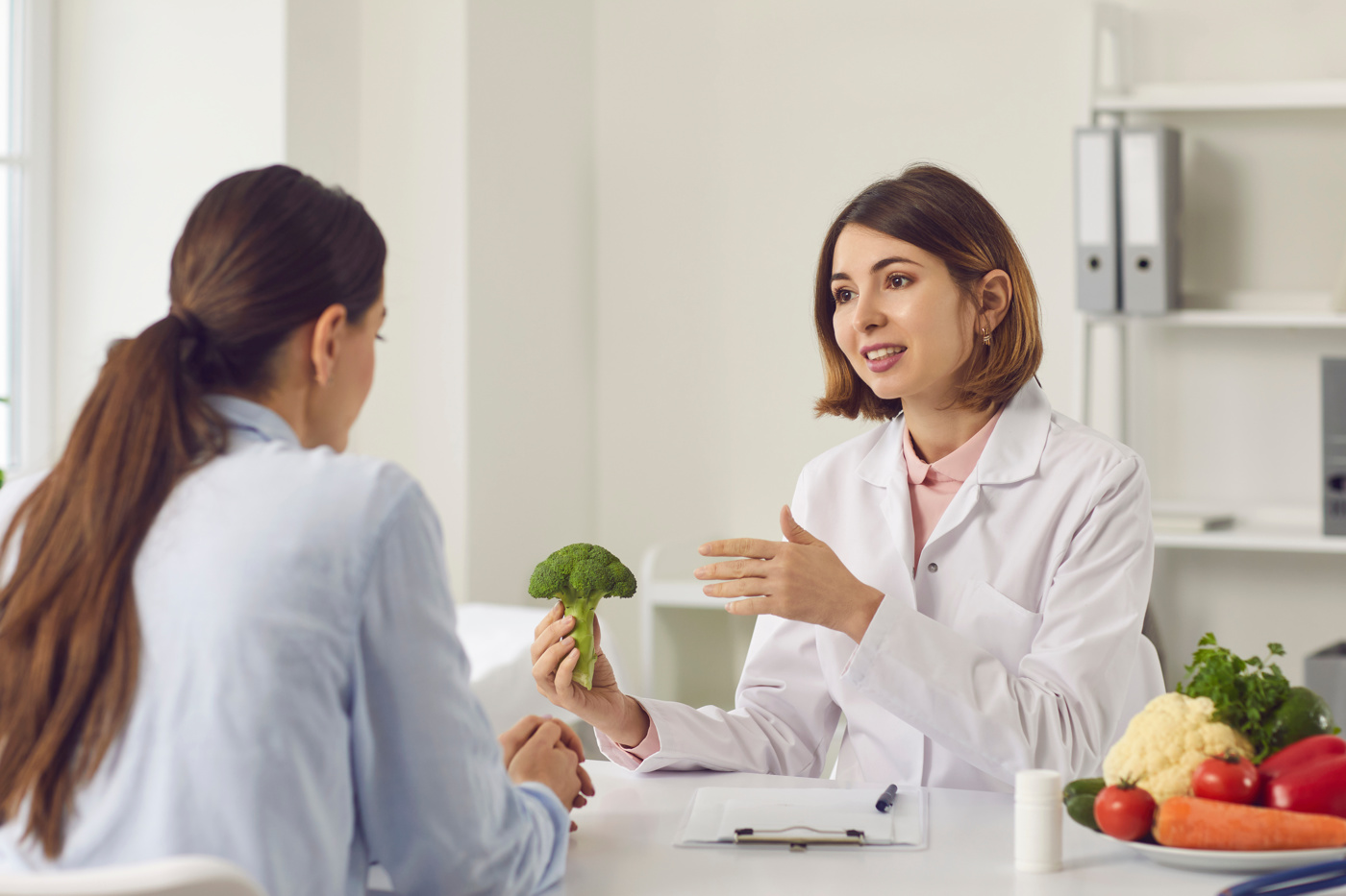 Un nutrizionista mostra a un cliente i benefici di una dieta sana e consapevole.