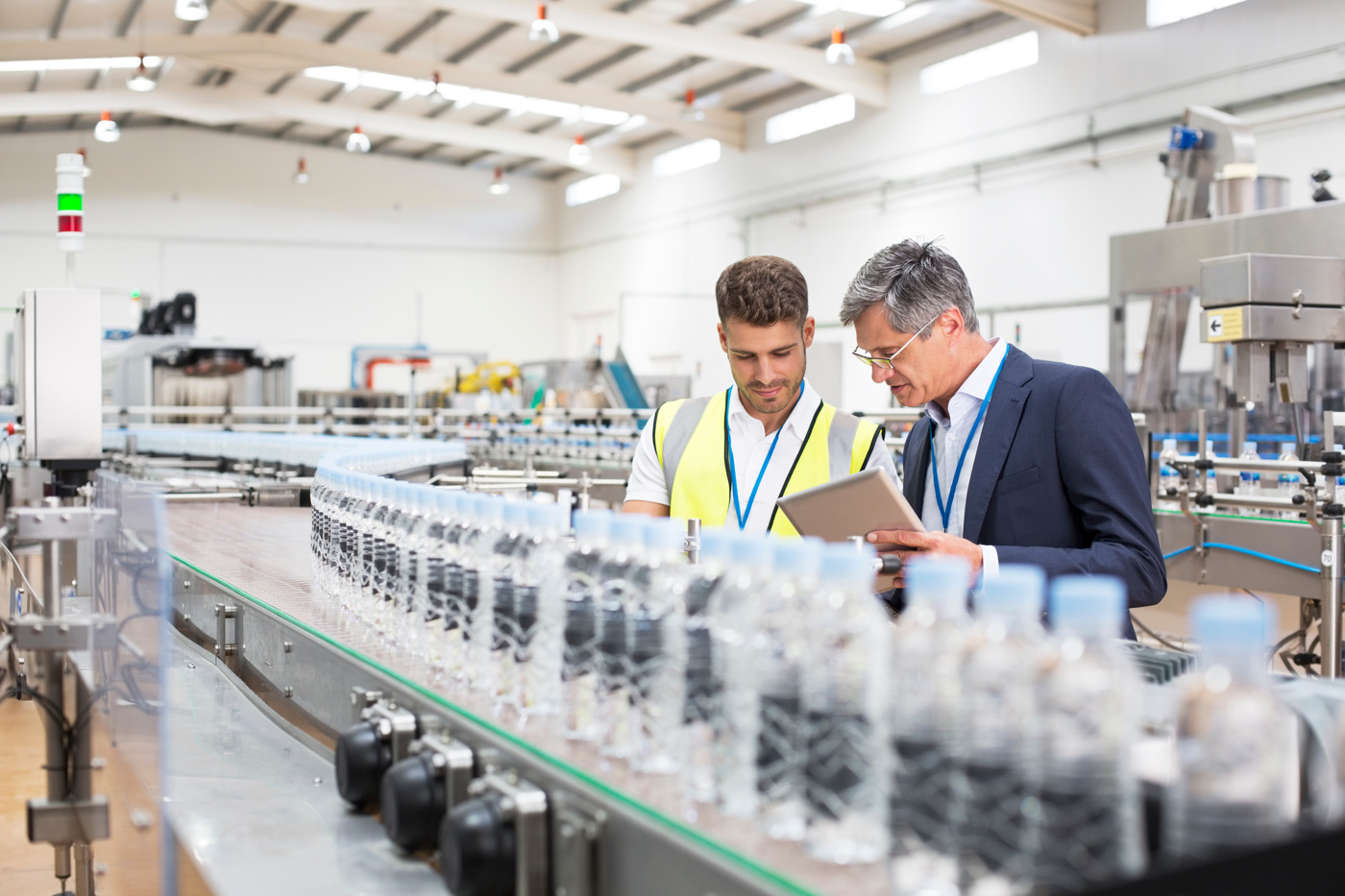 Quality managers check the quality assurance measures in a water bottle production facility.