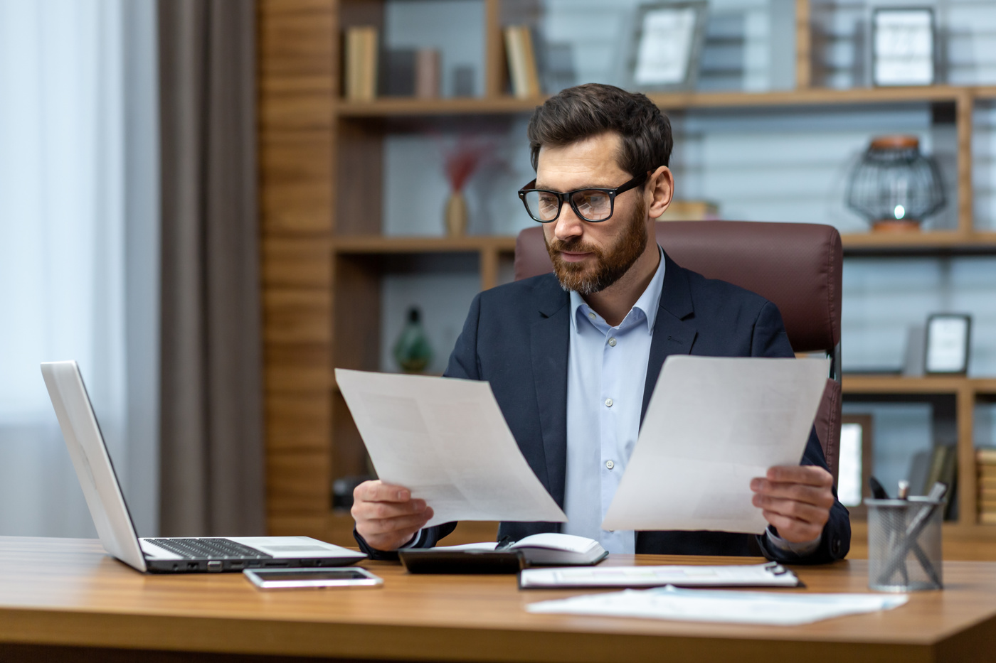 An insurance specialist draws up contracts for his client.
