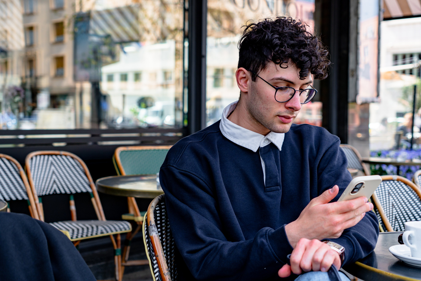 Giovane uomo che incontra amici in un caffè per imparare il francese in pratica durante il suo stage di francese all'estero