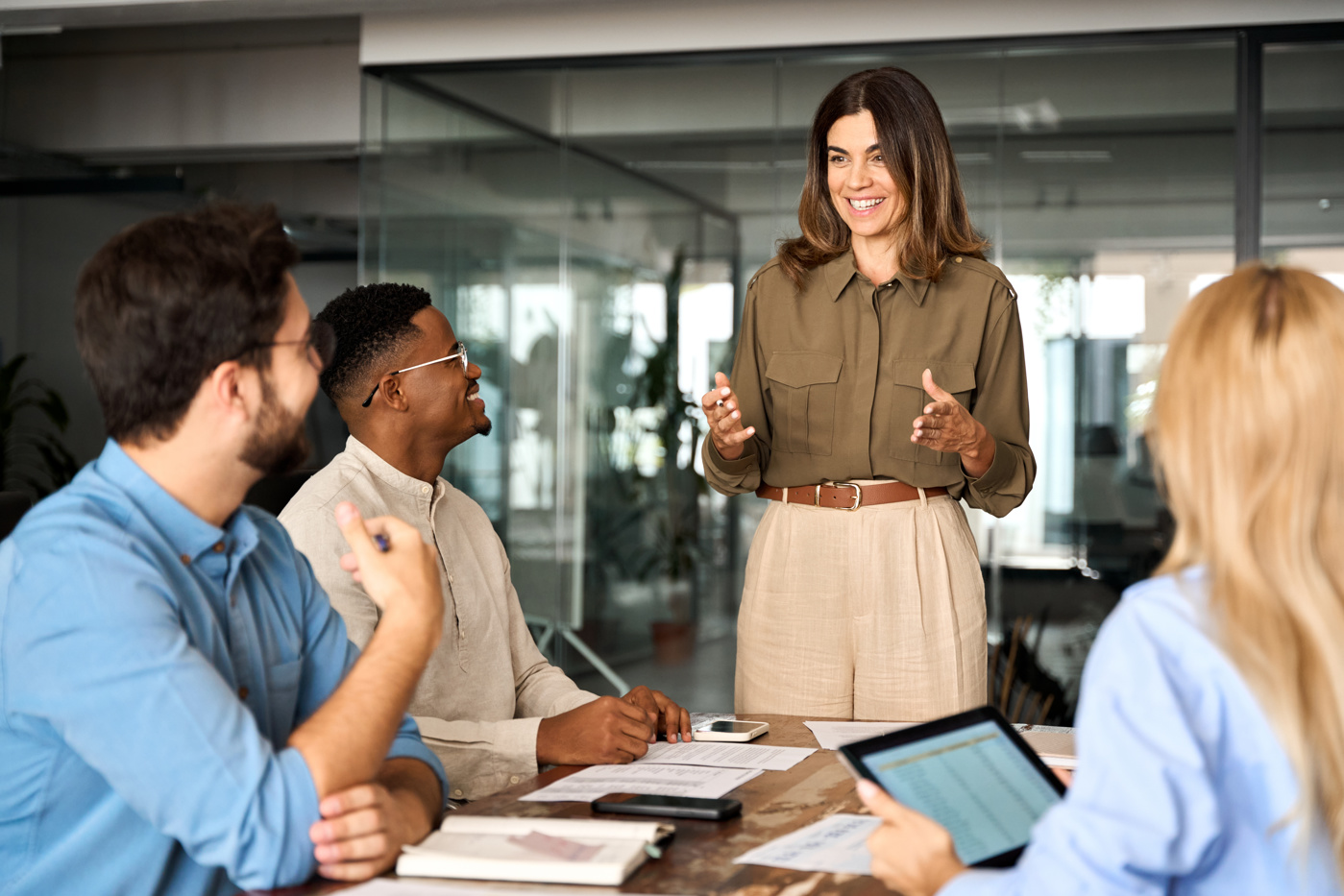 A sales manager informs her team about current events and upcoming tasks