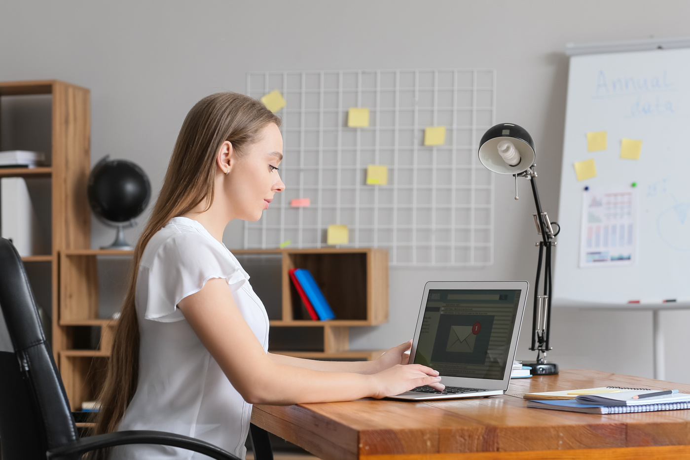 A woman is writing a business correspondence.